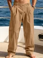 Detail shot of men's loose khaki trousers featuring drawstring waist on yacht deck - Earthy Yellow