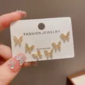Close-up of three pairs of elegant gold-toned butterfly stud earrings with crystals - 36# Gold - Full Diamond Butterfly Three-piece Earring Set (thickened Real Gold Plating)