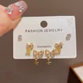 Close-up of elegant pink bowknot earrings set on white jewelry card, detail view. - 7# Gold - Full Diamond Bow Star Set (thickened Real Gold Plating)