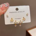 Detailed view of three-piece Korean style elegant earring set on white jewelry card. - 22# Gold-zircon Planet Three-piece Set (thickened Real Gold Plating)