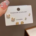 Close-up of three pairs of elegant golden stud earrings featuring crystal swan designs - 23# Gold Swan Three-piece Earring Set (thickened Real Gold Plating)