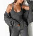 Detail view of a dark grey ribbed knitted tank top with slim fit stretch design - XS / Gray