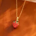 Delicate gold-tone necklace featuring a cute red enamel strawberry pendant charm - Gold Full Strawberry Style (TL9342)