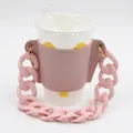 Stylish pink leather coffee cup sleeve featuring a thick detachable chain handle - Pink