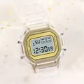 Detailed close-up of a transparent digital watch featuring a gold dial on a mesh background - Gold
