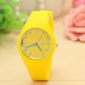 Detailed macro view of a vibrant yellow silicone Geneva watch with minimalist blue dial - Yellow