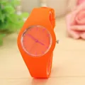 Close-up detail shot of a vibrant orange silicone jelly quartz watch with pink indices - Orange