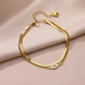 Elegantes zweilagiges goldenes Edelstahl-Fußkettchen mit bösem Blick und Herz. - Böser Blick Runde Platte Stil (HJ366G)