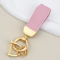 Elegant pink goat grain leather car keychain with matte gold circular hardware charm - Independent Matte Bag Packaging / Pearl Gold-Pink