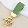Premium green goat grain leather car keychain featuring elegant matte gold hardware - Independent Matte Bag Packaging / Pearl Gold-Green