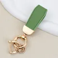 Premium green goat grain leather keychain with elegant gold-plated hardware for cars. - Gold-green / Individually Packaged Frosted Bags