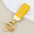 Premium yellow goat grain leather car keychain with elegant matte gold metal hardware - Independent Matte Bag Packaging / Pearl Gold-Yellow