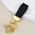 Elegant goat grain leather keychain with gold-finished rings in black finish - Independent Matte Bag Packaging / Gold-Black