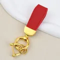 Red goat grain leather car keychain featuring premium gold finish hardware attachment - Independent Matte Bag Packaging / Gold-Red