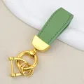 Elegant sage green goat grain leather keychain with polished gold-tone metal ring hardware - Independent Matte Bag Packaging / Gold-Green