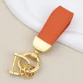 Premium goat pattern orange leather car keychain with matte gold hardware and D-ring - Independent Matte Bag Packaging / Pearl Gold-Orange