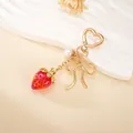 Sweet red acrylic strawberry keychain featuring a golden bow and heart-shaped clasp charm - Small Pendant / Red Transparent Strawberry Charm(K6025)