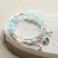 Elegant light blue beaded bracelet with ocean charms including shell and starfish. - Pearl Shell - Blue