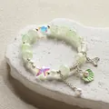 Ethereal forest style green beaded bracelet featuring starfish and shell charms. - Pearl Shell - Green