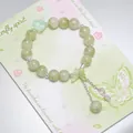 Forest style green beaded bracelet with translucent butterfly and silver leaf charms - Ink Butterfly Rose Green