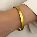 Hammered texture gold stainless steel cuff bracelet on wrist - Hammered Texture (N-723)