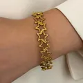 Bohemian style gold stainless steel bracelet featuring textured hollow star links - Multi Star Link (8882)