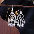 Bohemian ethnic style silver dangle earrings featuring iridescent opalescent stones. - Silver