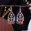 Elegant Bohemian ethnic silver chandelier earrings featuring vibrant red beads and crystals - Silver