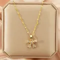 Elegant gold necklace with sparkling zircon bow-knot pendant on jewelry display box. - 147#XL1470-32