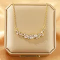 Elegant gold necklace featuring a curved pendant with clear cubic zirconia stones. - 153#XL1470-51