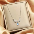 Angel wings necklace featuring a light blue teardrop stone pendant on box - 155#XL1470-55