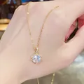 Elegant gold stainless steel necklace with sparkling round zircon pendant on hand. - 159#xl1780-37 Titanium Steel With Real Gold Plating