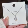 Elegant silver stainless steel necklace with a round halo crystal pendant on a white card - 179#XL1993-9