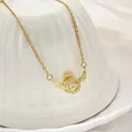 Elegant gold-toned stainless steel necklace featuring a winged circular crystal pendant. - 183#XL2167-03