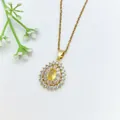 Elegant gold necklace with a yellow teardrop gemstone pendant surrounded by crystals. - 193#XL1200-405