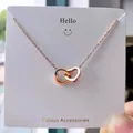 Minimalist rose gold stainless steel interlocking heart pendant necklace on display card - 103#XL1338-08