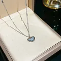 Elegant silver-toned heart pendant necklace with Love engraving displayed in a jewelry box - 106#XL1338-24
