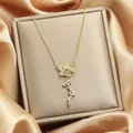 Elegant gold floral pendant necklace with sparkling rhinestone cluster on silk background - 99#XL1200-124