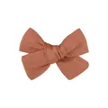 Detailed close-up shot of a handmade rust-colored terracotta linen bow hair clip - Rust Red Cotton Linen Bowknot