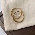 Classic 2.5cm gold-plated thick hoop earrings for women, minimalist retro jewelry style. - 25mm / Gold