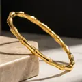 Elegant gold titanium steel bangle featuring a minimalist natural bamboo joint design - Gold Round Bamboo Bangle (14-B-7)