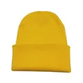 Detailed view of a bright yellow knitted beanie hat featuring a soft warm wool texture. - Yellow