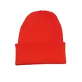 Detailed macro view of the vibrant orange knitted beanie hat showing thick winter yarn texture - Watermelon red