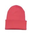Close-up detailed view of the coral red ribbed knit beanie featuring a folded cuff - Peach