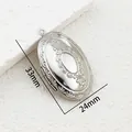 Detail shot of a vintage oval stainless steel photo locket with 33mm x 24mm dimensions - YY026