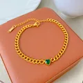 Detailed view of a gold-plated titanium steel necklace with a green heart zircon. - Gold Chain with Green Rhinestone (X2173)