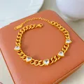 Detailed view of a gold-plated titanium steel necklace featuring radiant heart-shaped zircons. - Gold with 5 White Hearts Style (X2178)