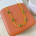 Detailed macro view of a gold plated heart necklace with green zircon on a jewelry box - Gold with 5 Green Hearts Style (X2181)