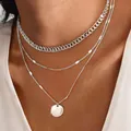 Close-up view of a layered silver curb chain necklace with a circular coin pendant - Round Disc 3mm Magic Flattened Chain / Silver