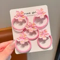 Set di cinque elastici per capelli a fiore di ciliegio rosa per ragazze su carta bianca - Piccolo elastico sottile fiori di pesco